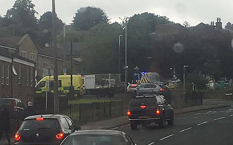 Handout photo taken with permission from the twitter feed of @ScotsFootyCards of police close to the scene in Birstall