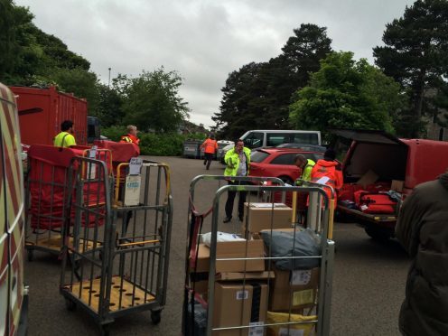 Staff sorting the mail outdoors