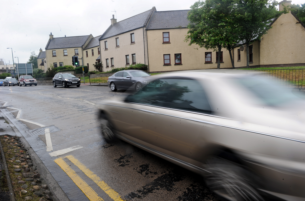 Cars on Alexandra Road, Elgin, going past the back of houses on Murdoch's Wynd.
Picture by Gordon Lennox