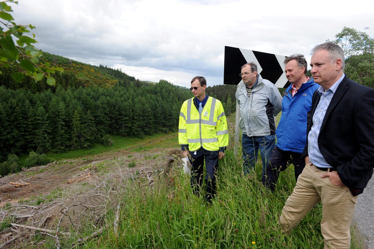 Dave Malpas, Senior Engineer Traffic for Moray Council, Cllr. Mike McConnachie, George Tulloch, secretary of Dufftown and District Community Council, and MSP Richard Lochhead beside the steep drop alongside the B9014, Dufftown to Keith road, which campaigners think should be protected by barriers.