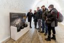 Visitors look at exhibits in Fort George