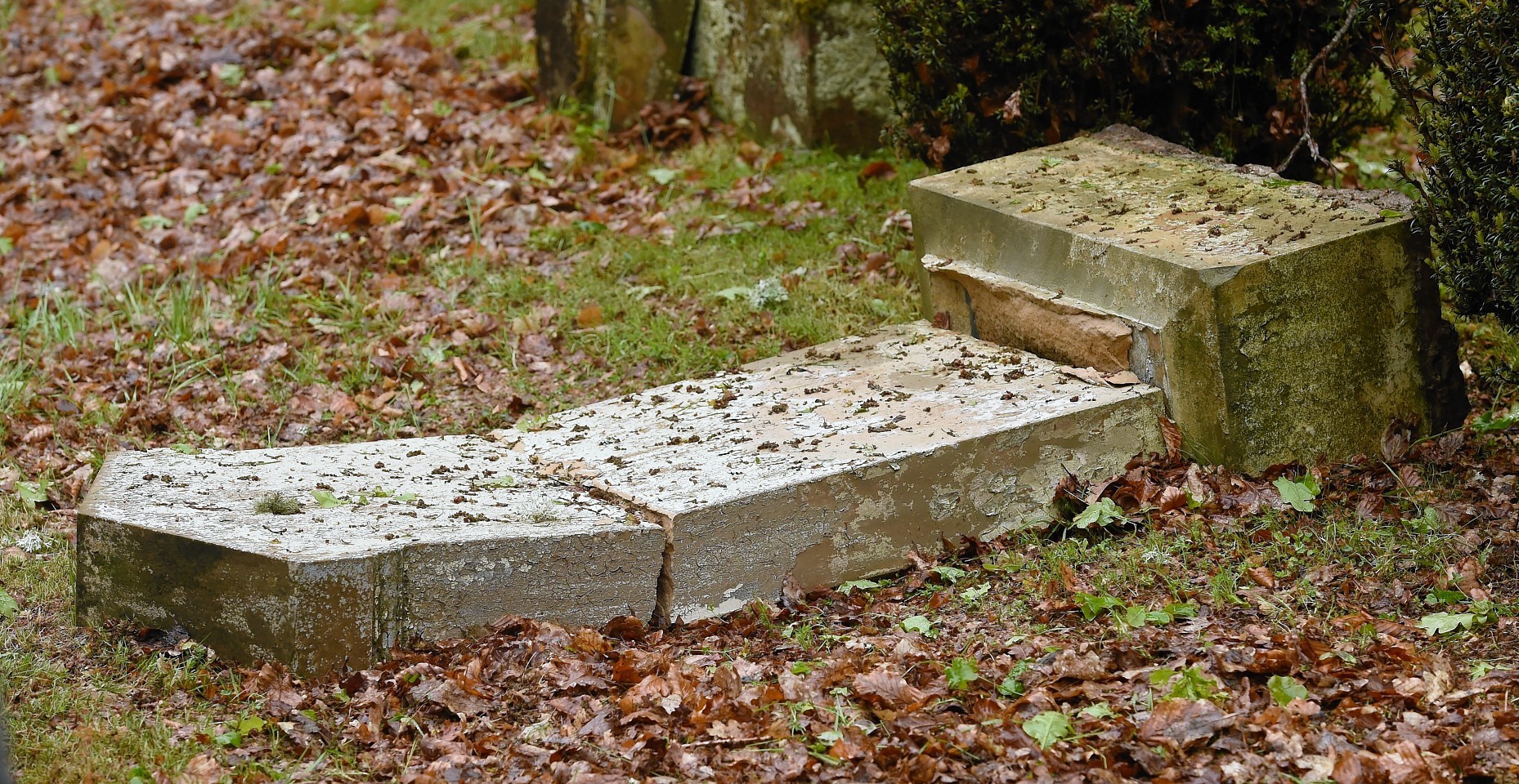 Dozens of damaged and broken grave stones in the Tomnahurich Cemetery