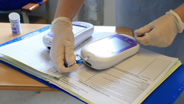 A nurse gives a patient a diabetes test