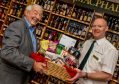 David Morgan from Piping At Forres and Mark Angus of Gordon and MacPhail show off one of the hampers.
