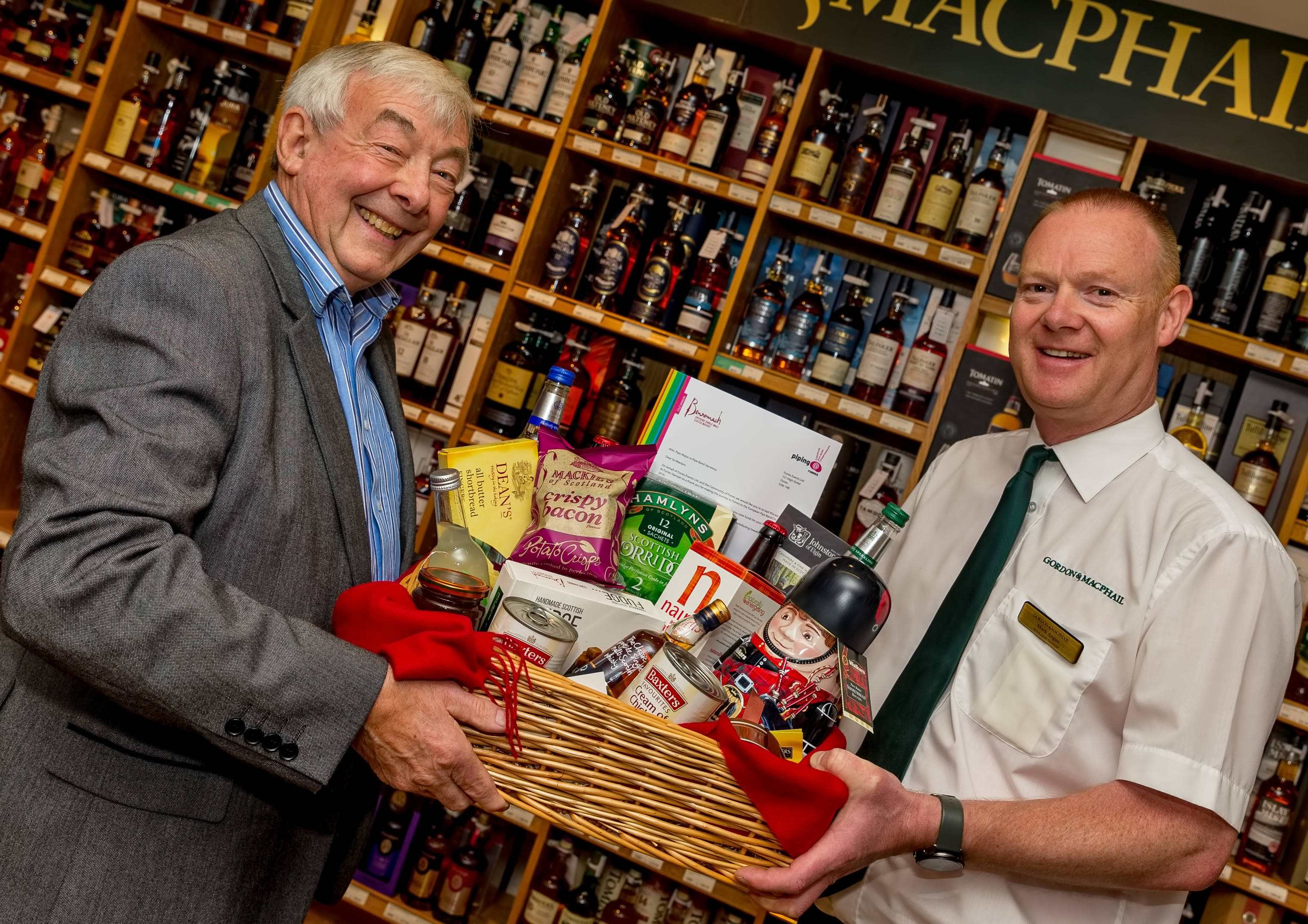 David Morgan from Piping At Forres and Mark Angus of Gordon and MacPhail show off one of the hampers.