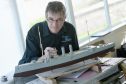 Paul Tyer working on his model of the HMS Hampshire