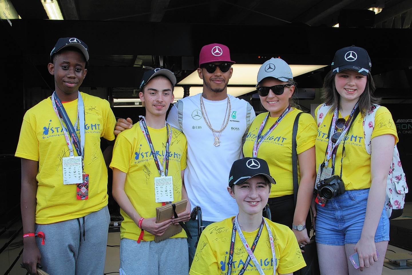 Polly Melville (right of Lewis Hamilton) meeting the F1 driver at the Monaco Grand Prix
