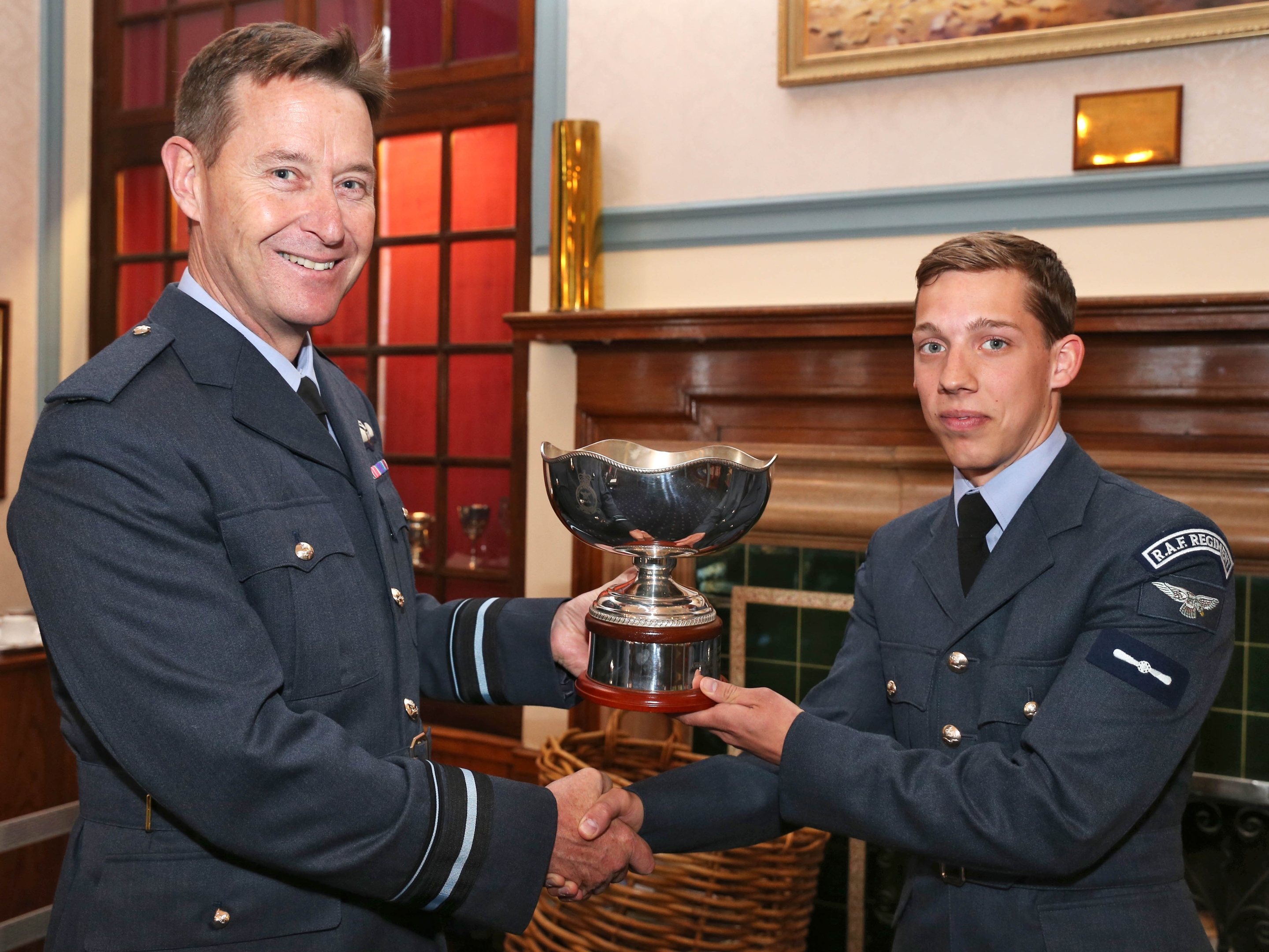 Air Vice-Marshal Gavin Parker, Air Officer Commanding 2 Group presents the McFerran Prize to SAC James Lewis, 51 Squadron RAF Regiment.