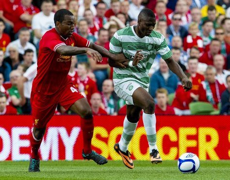 Andre Wisdom challenges Celtic forward Amido Balde