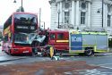 A view of the scene following a collision involving a bus, fire engine and car