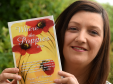 Irene Penman with her book, where the poppies are
