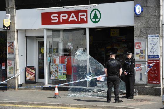 Police investigate the scene of the break-in. Pictures by Kenny Elrick