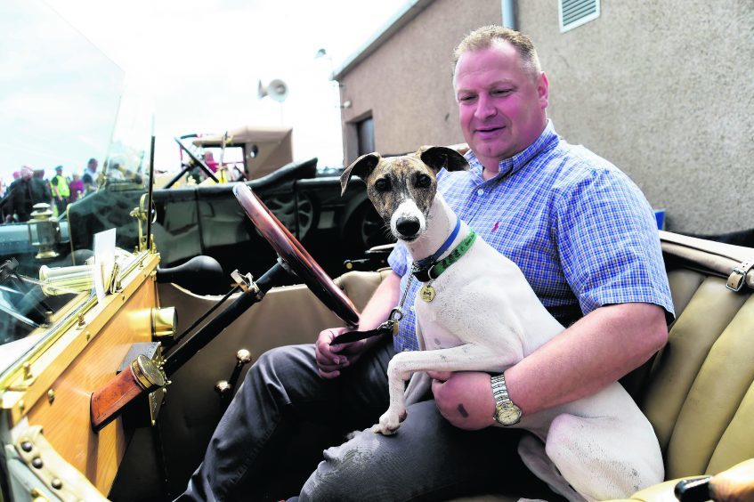 JIM BRUCE FROM ST FERGUS AND HIS DOG GINO HAVE A SEAT IN HIS 1915 ALLDAYS AND ONIONS
