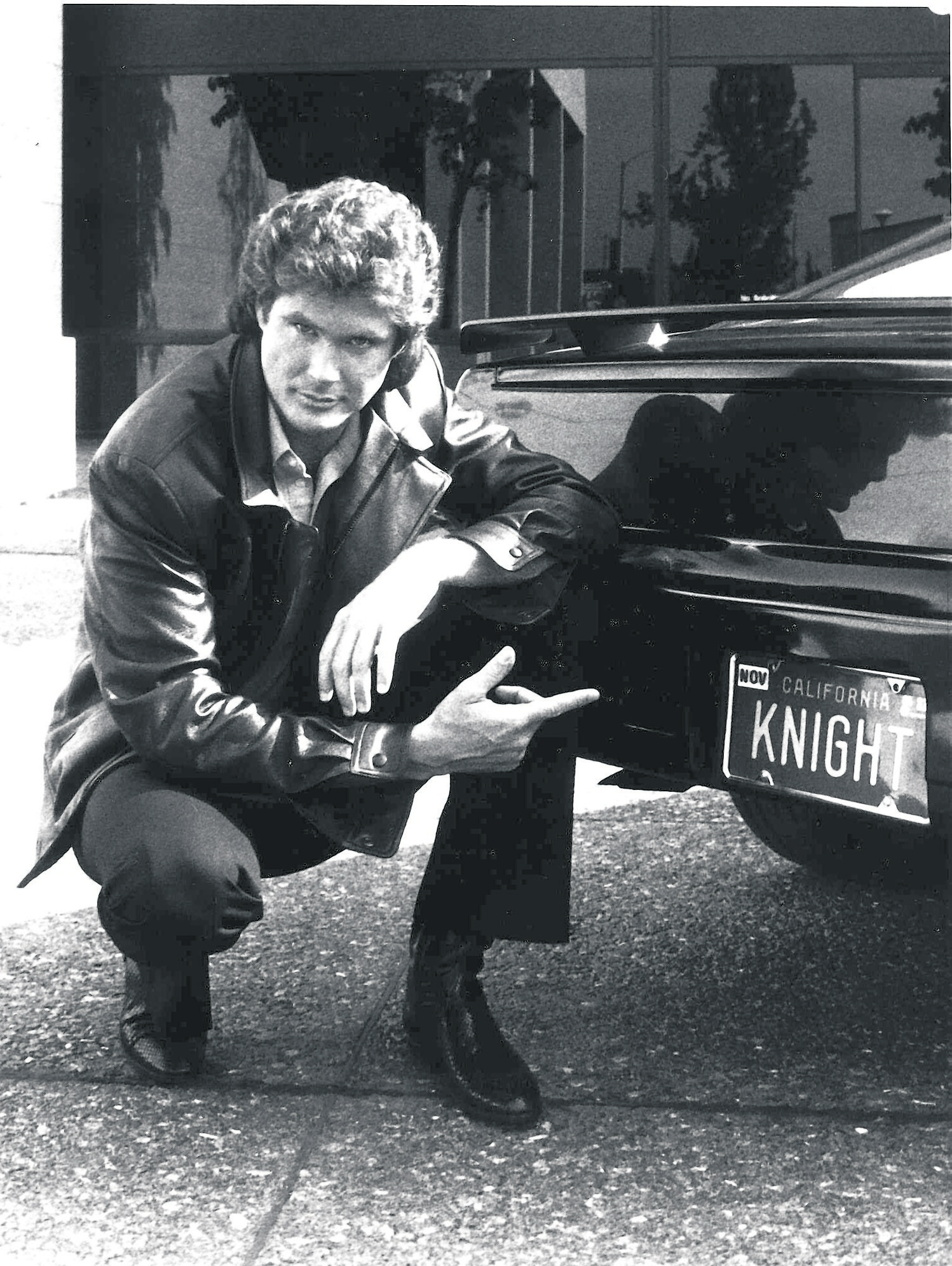 **FILE** An April 5, 1985 file photo David Hasselhoff, star of NBC's series, "Knight Rider," points to the back of the his car, KITT. The flame-throwing, river-jumping, talking muscle car from the 1980s TV show is up for sale. Restored to its debut-season glory, the modified black 1982 Pontiac Trans Am is offered at $149,995 at a Dublin, Calif., auto dealership. (AP Photo/NBC)