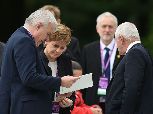 Nicola Sturgeon stands with Carwyn Jones as they wait to take their seats at the Commemoration of the Centenary of the Battle of the Somme at the Commonwealth War Graves Commission Thiepval Memorial