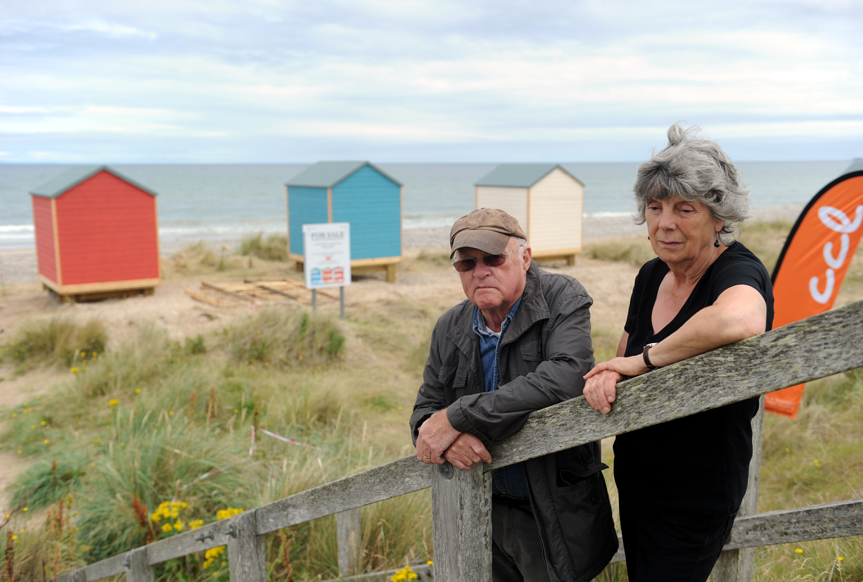 Margaret and Bill Ogilvie beside the beach huts at Findhorn which they vigorously fought against. Picture by Gordon Lennox.