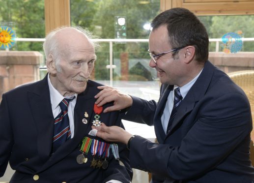 French Consul General Emmanuel Cocher presents the Légion d'honneur to Alex MacLachlan