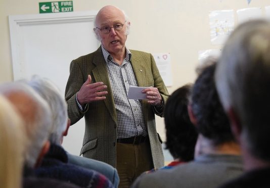 Trust chairman John Hutchison explains the proposed community buyout at the meeting in Inverlochy