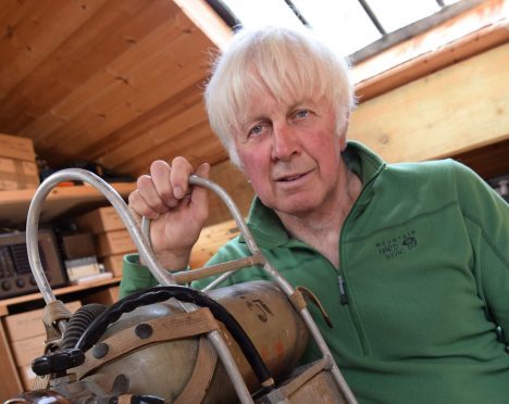 Mick Tighe with one of the exhibits, oxygen bottles used on the 1953 conquest of Everest expedition