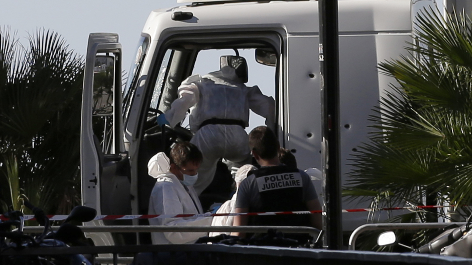 Forensic police officers work at the truck that plowed into the crowd in Nice (AP)