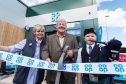 Store manager Sharon Cossans, local historian Fred Stewart and young piper, Tain Robbie, from Newtonhill Pipe Band cut the ribbon at the new Co-op store in Leathan Fields.