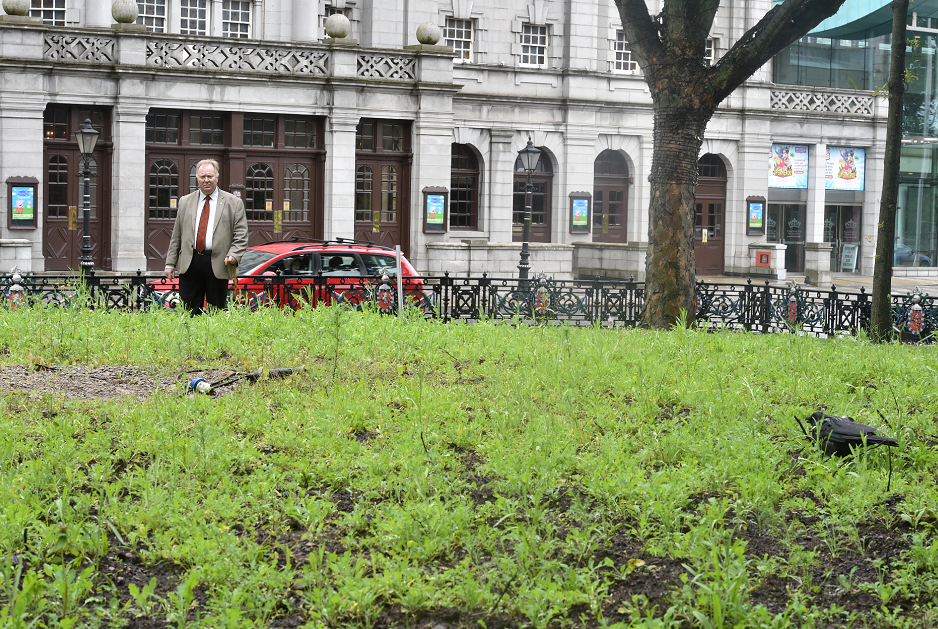 Aberdeen Councillor Bill Cormie inspects the weeds and long grass at the area opposite HMT