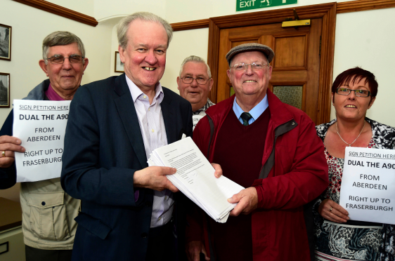 MSP STEWART STEVENSON RECEIVES A PETITION FROM CLLR IAN TAIT WITH OVER 4000 SIGNATURES ASKING FOR THE A90 TO BE DUALLED ALL THE WAY TO FRASERBURGH.LOOKING ON ARE (L TO R) COMMUNITY COUNCILLORS GEORGE ESSLEMONT, WILSON WHYTE AND PAULINE MASON.