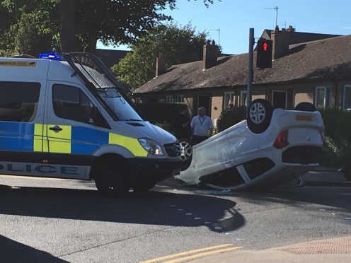 Woman and baby rushed to hospital after car flips on roof