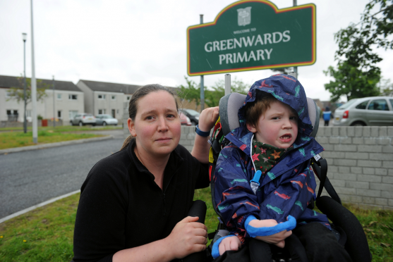 Gillian Groves and her son, Tom, outside Greenwards Primary School, Elgin, which he attends. Picture by Gordon Lennox.