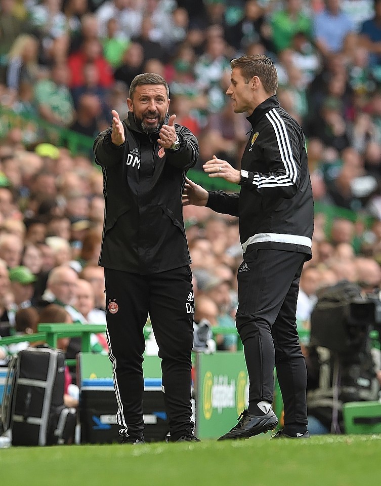  Aberdeen manager Derek McInnes speaks with the assistant