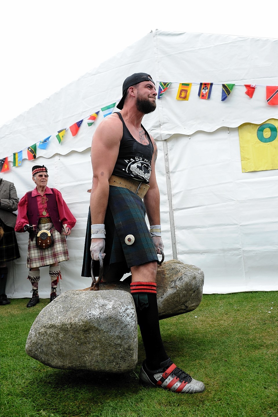 Steve Gardner takes on the mighty Dinnie Steens at Aboyne Highland Games yesterday. Credit: Kenny Elrick.