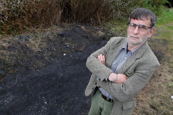 Councillor Donnie Kerr at the spot where a caravan was set ablaze on Sunday.