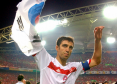 Turkey's Hakan Sukur holds a South Korean flag at the end of the 2002 World Cup third place playoff
