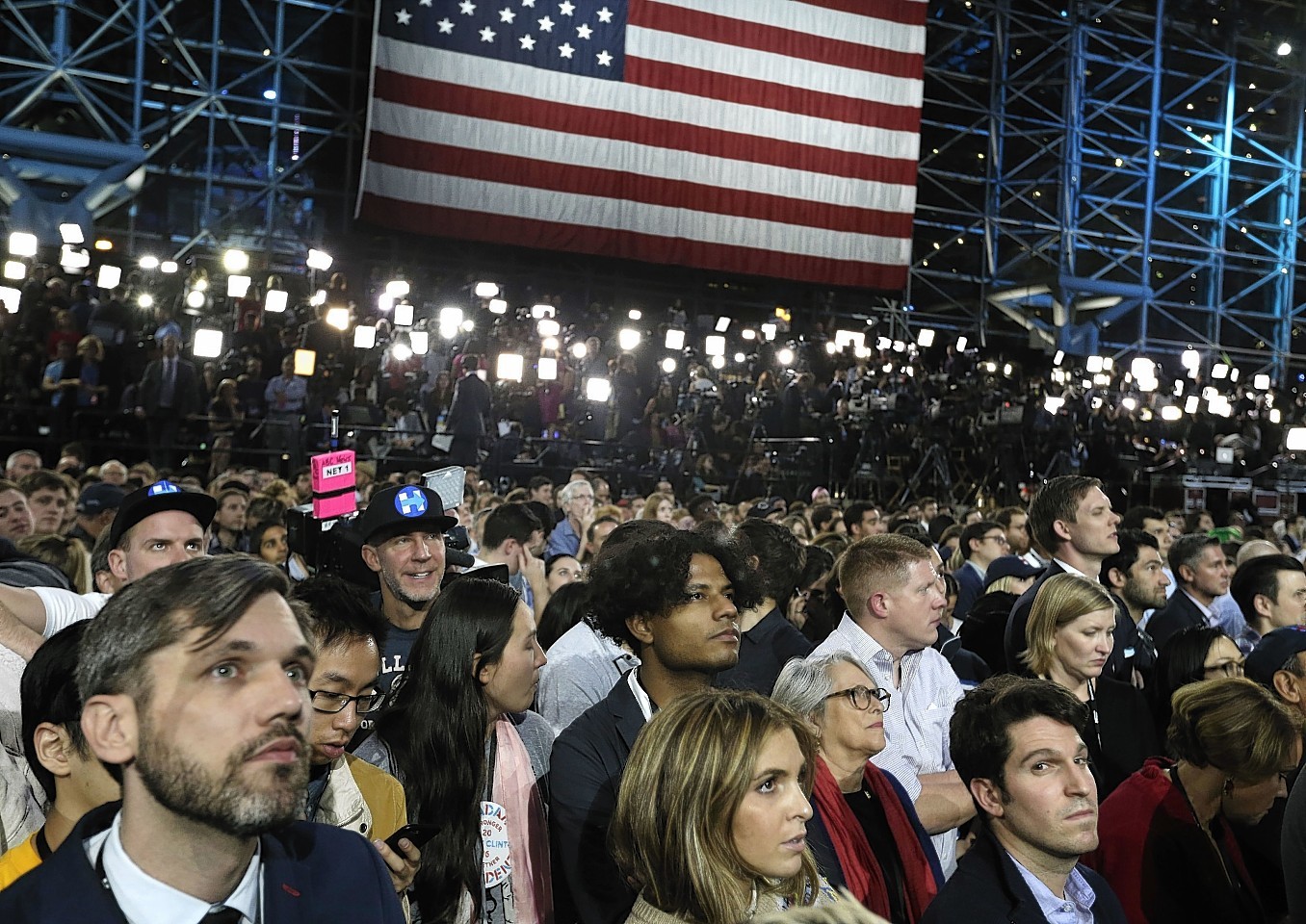 Supporters watch election results during Democratic presidential nominee Hillary Clinton's election night rally in the Jacob Javits Center glass enclosed lobby in New York, Tuesday, Nov. 8, 2016. (AP Photo/Frank Franklin II)