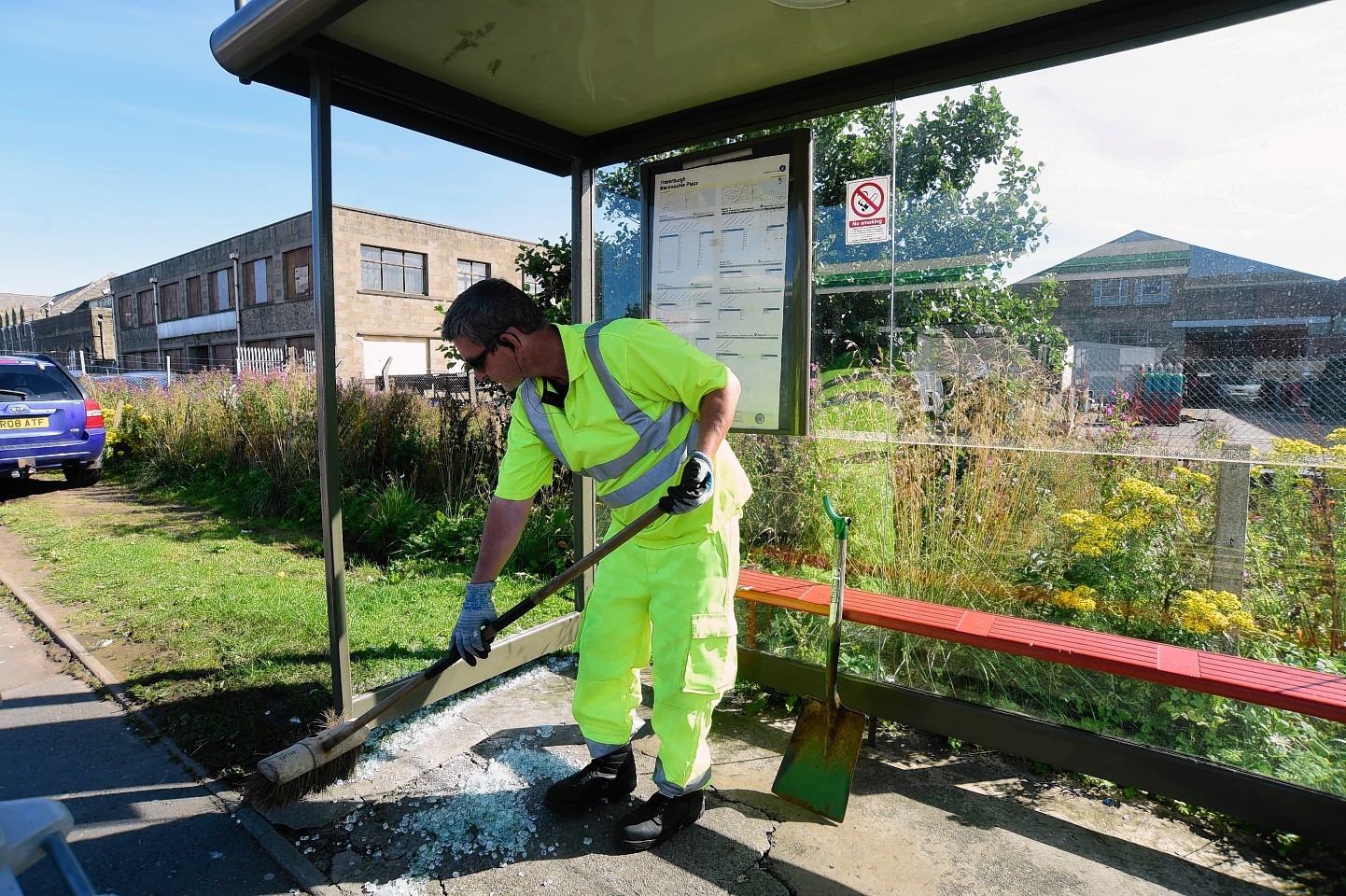 A council workman cleans up damage at a Fraserburgh bus shelter