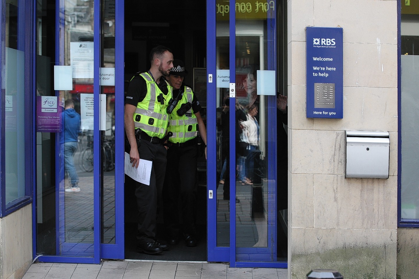 Police at the scene after the bag snatch in RBS, Inverness