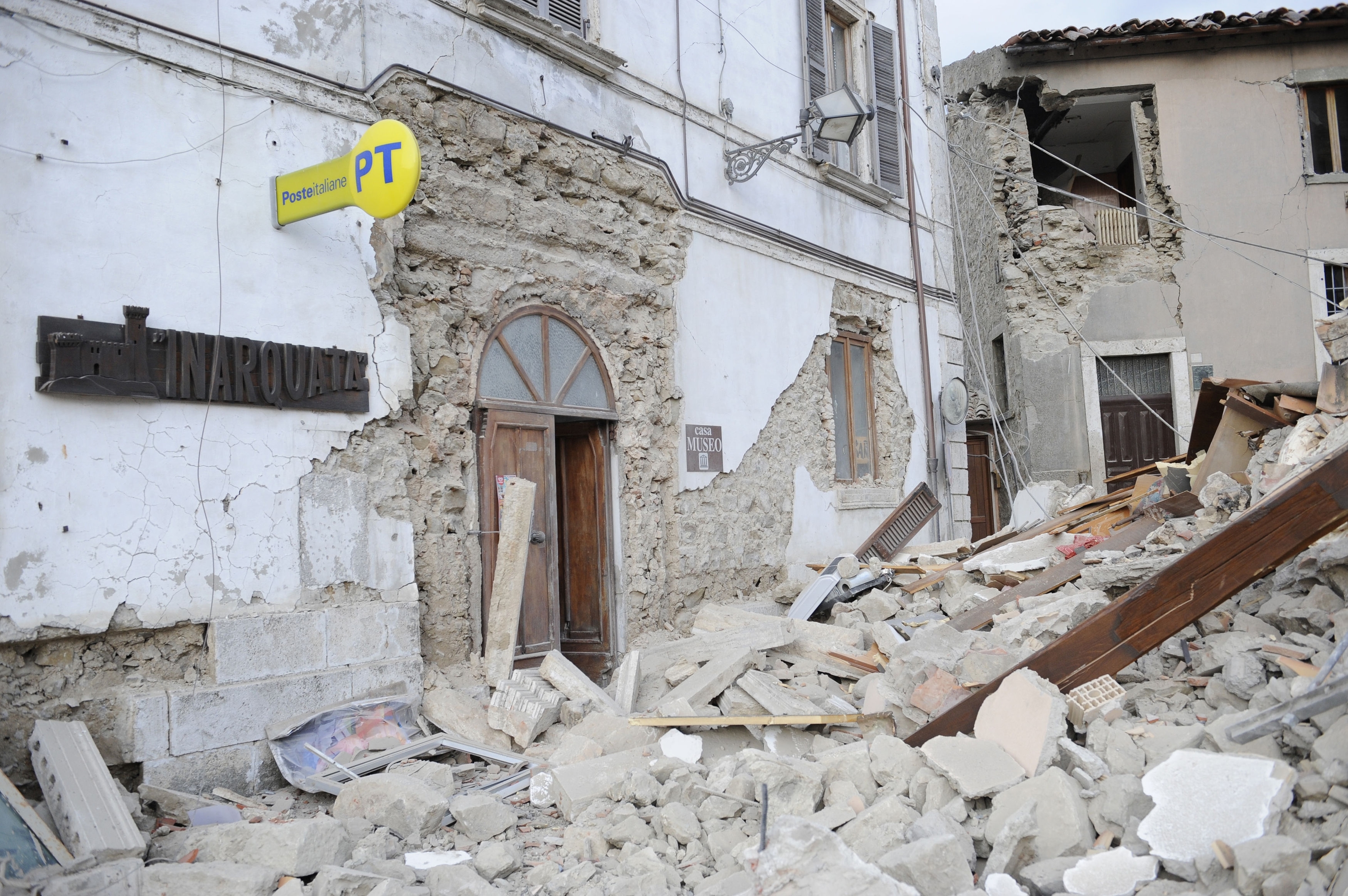 A post office is engulfed by rubbles in Arcuata del Tronto, central Italy, 