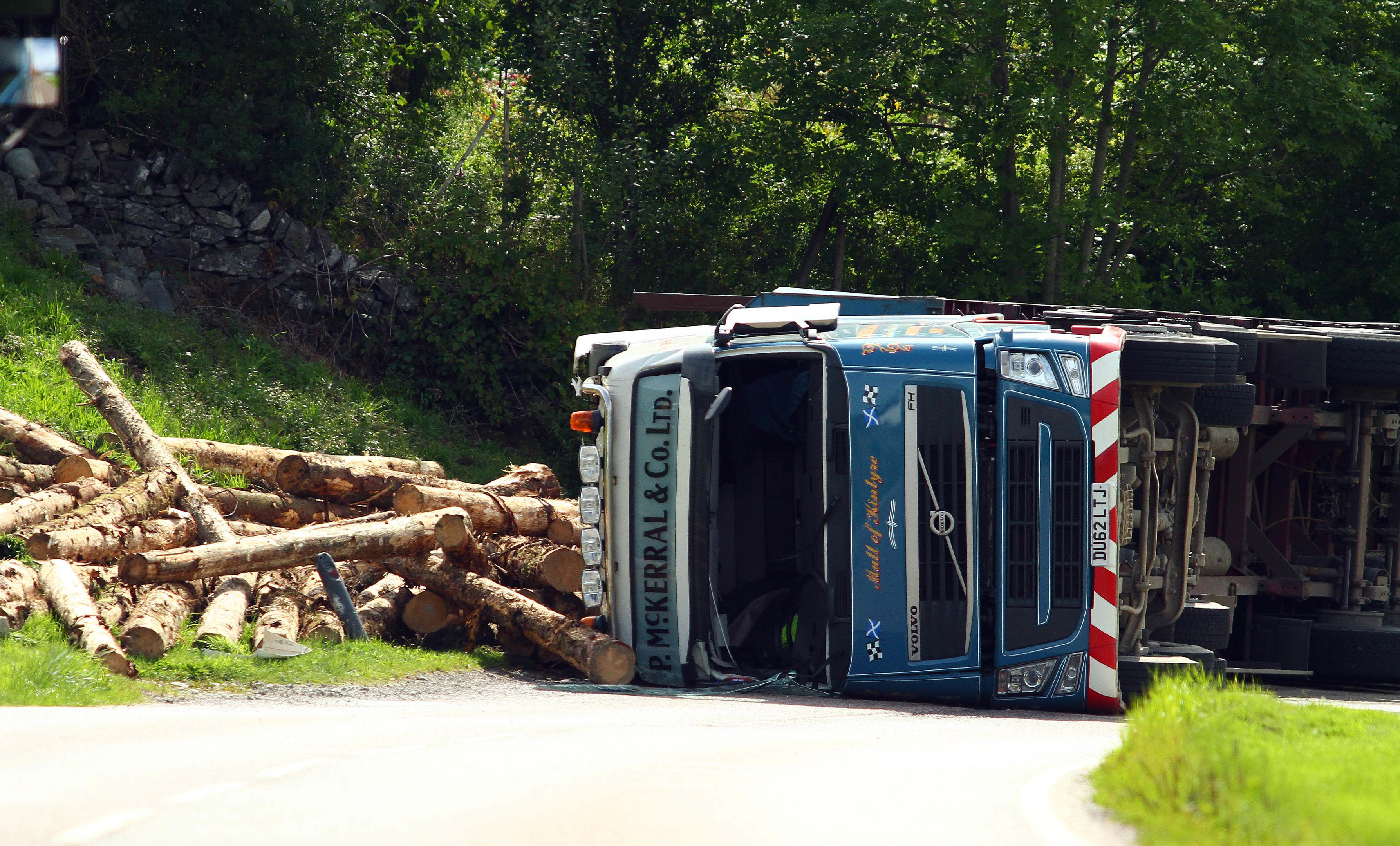 The occupants of two cars were very lucky to escape with their lives as a wood lorry shed its load in the village of Kilmartin argyll on the a816 between lochgilphead and and oban . The road was due to be closed for a considerable time to allow the police scotland to investigate and to clear the road of the damaged vehicles and debris picture kevin mcglynn