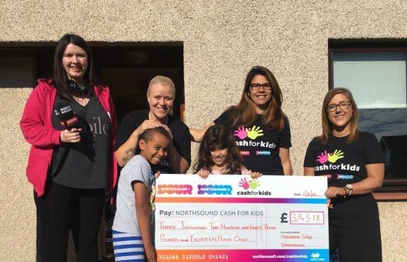 Nina Holmes (right) and Suzie McFadden (left) of Cash for Kids with Patricia Bruce (second right) and fellow residents of Malcolm's Way Stoneh