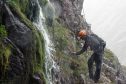 Dave Buckett carries out an examination on the North Face of Ben Nevis