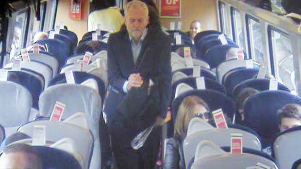 Labour Party leader Jeremy Corbyn walking past several empty unreserved seats (Virgin Trains/PA)