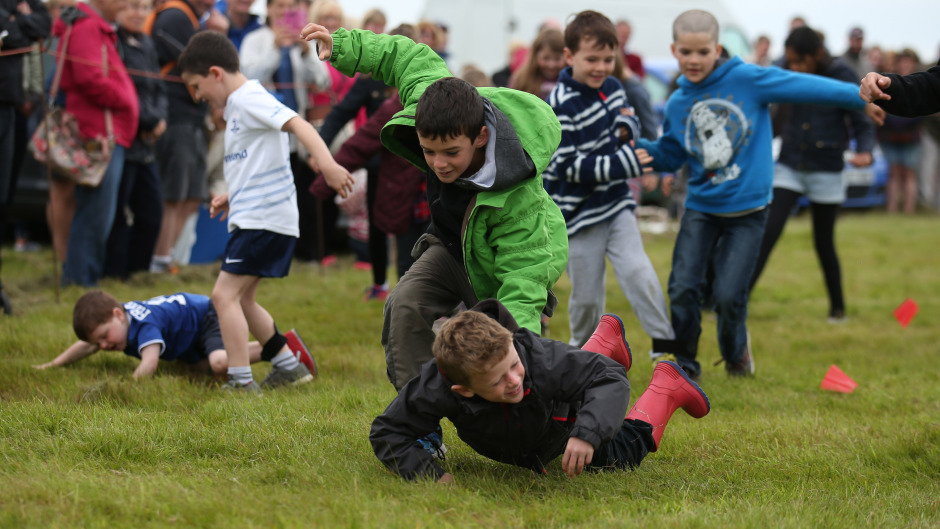 Children take part in a three legged race at the Mey Highland games