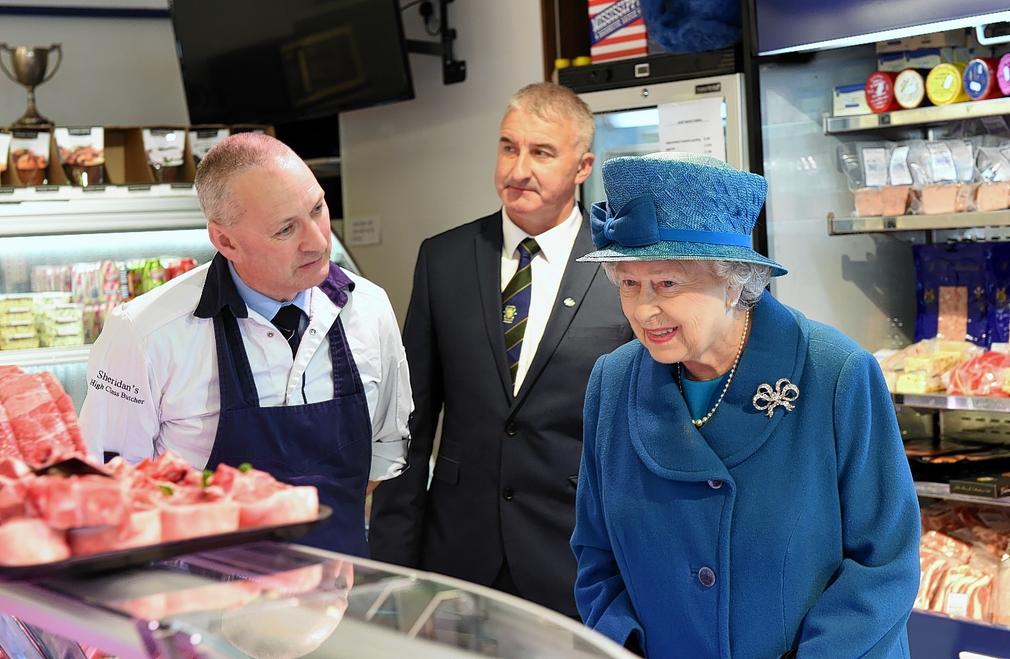 The Queen with Barry Florence, left, and John Sinclair, right - owners of HM Sheridans Butchers