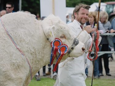 Raymond Irvine with his champion Charolais bull
