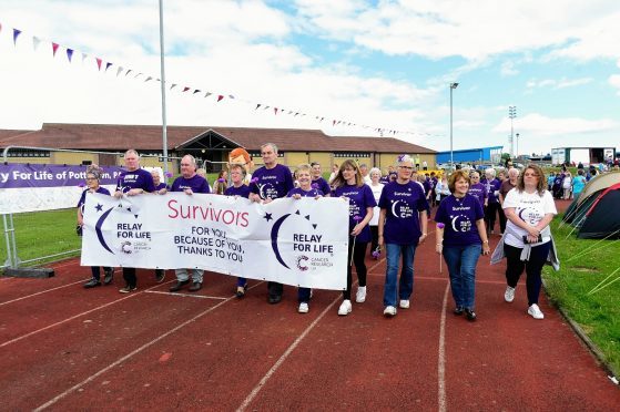 Survivors complete the lap of honour at Relay for Life