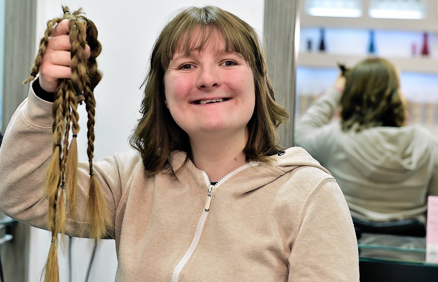 Sarah Rawlinson holds a lock of hair in Saks yesterday. Credit: Kami Thomson.