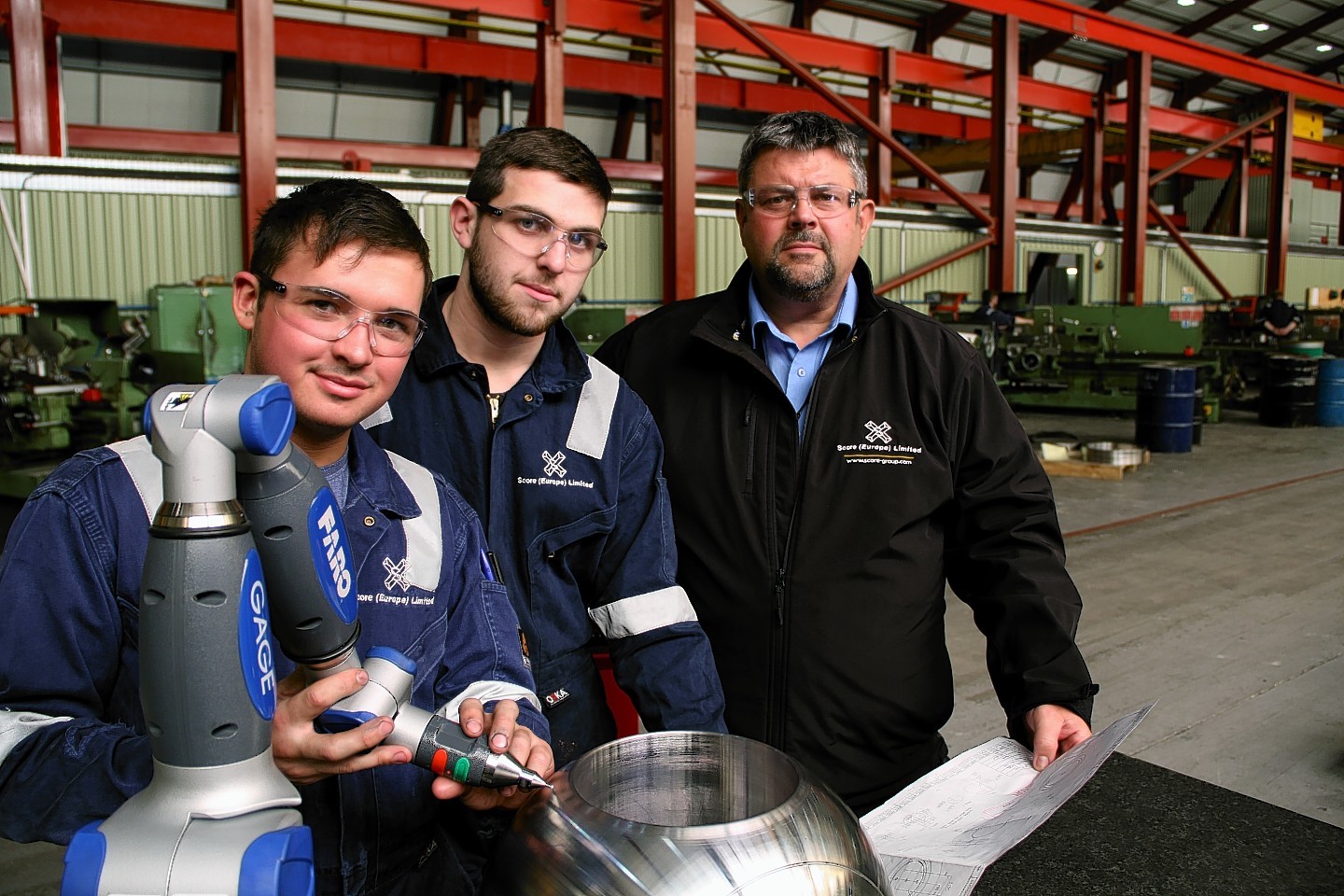 Score Group’s Conrad Ritchie with apprentices Ross Smith and George Heatherwick
