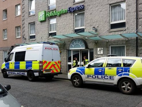 Police outside the Chapel Street hotel where 16 fans were arrested and later charged.