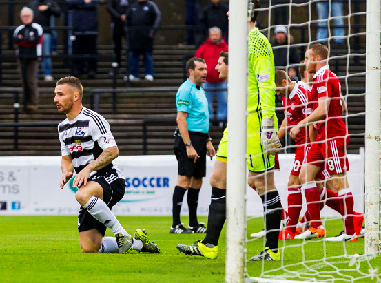  Ayr's Daryll Meggatt (L) looks dejected after he scores an own goal putting Aberdeen into the lead (0-1)