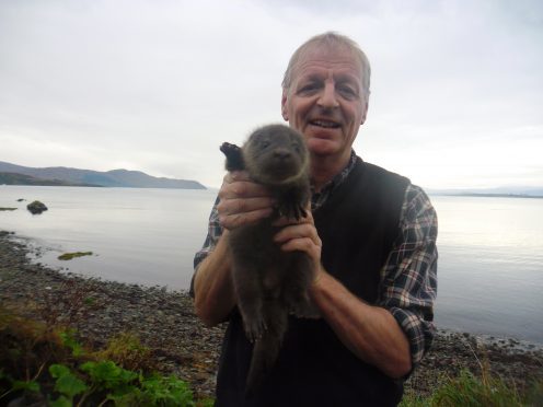 Dr Paul Yoxon with a three week old orphaned otter cub